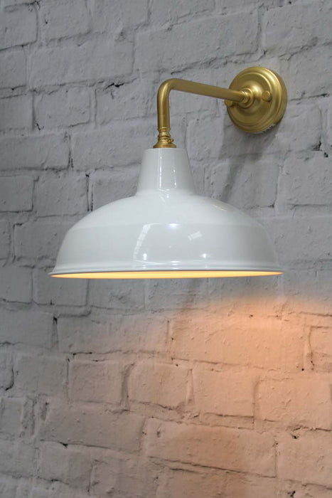 Warehouse shade in white with gold/brass wall sconce.