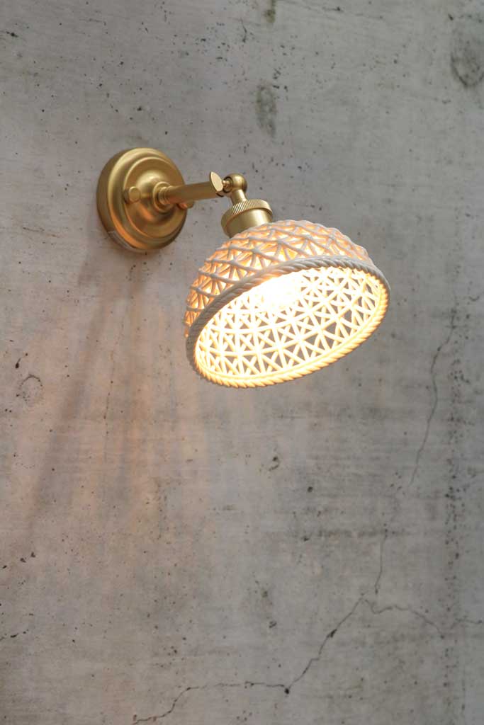 Gold/brass wall light with short ceramic shade