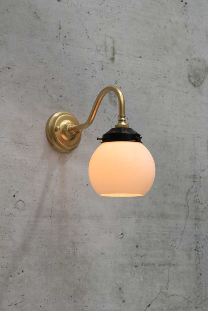 steel gooseneck wall light in gold/ brass finish with small opal shade