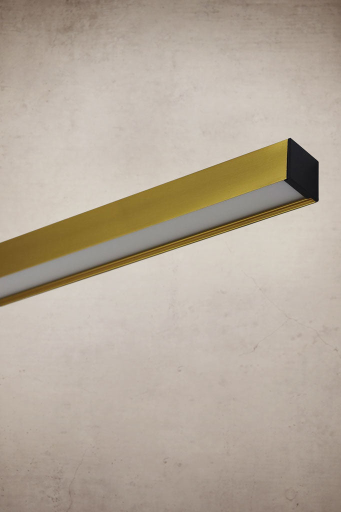 close up of gold linear pendant light