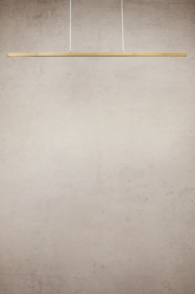 Gold/brass linear pendant light with stainless steel cables