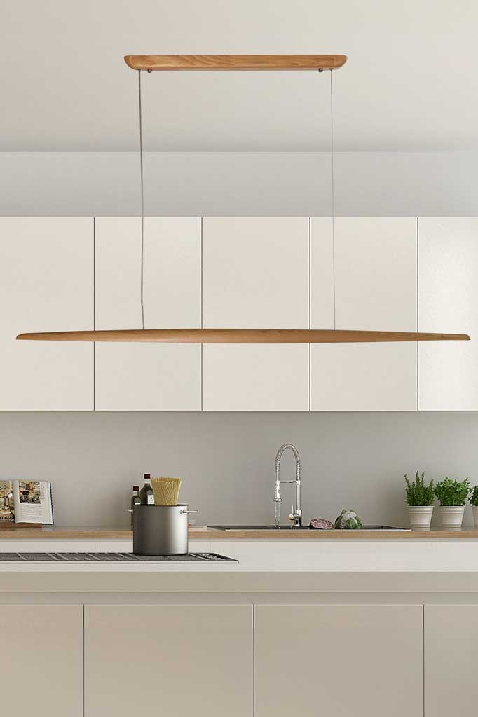 Timber liner pendant and ceiling mount suspended from stainless steal wires hanging in a neutral toned kitchen. 