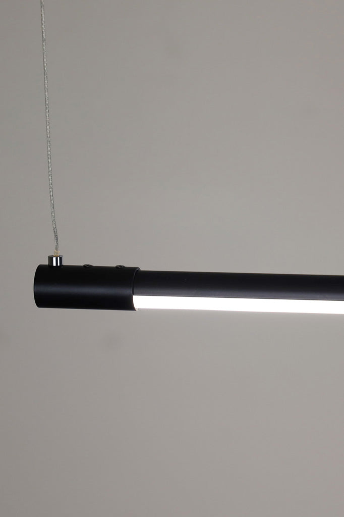 Close up of the Bremer black linear pendant and stainless steel wire join.