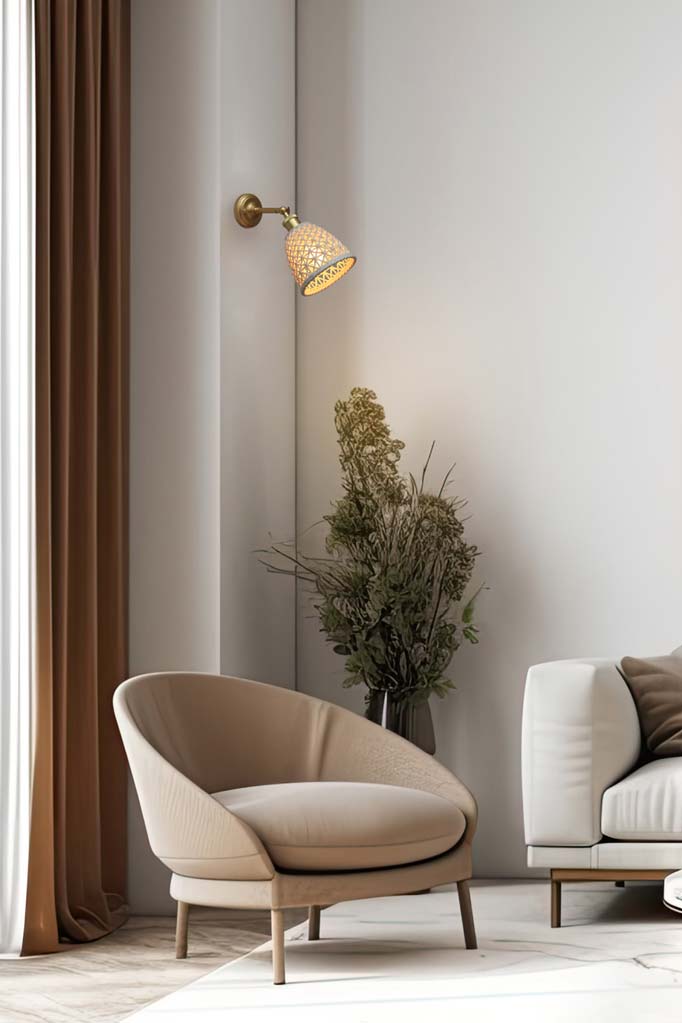 Tall basket weave look ceramic shade hanging on a gold/brass straight arm in a neutral toned lounge room.  