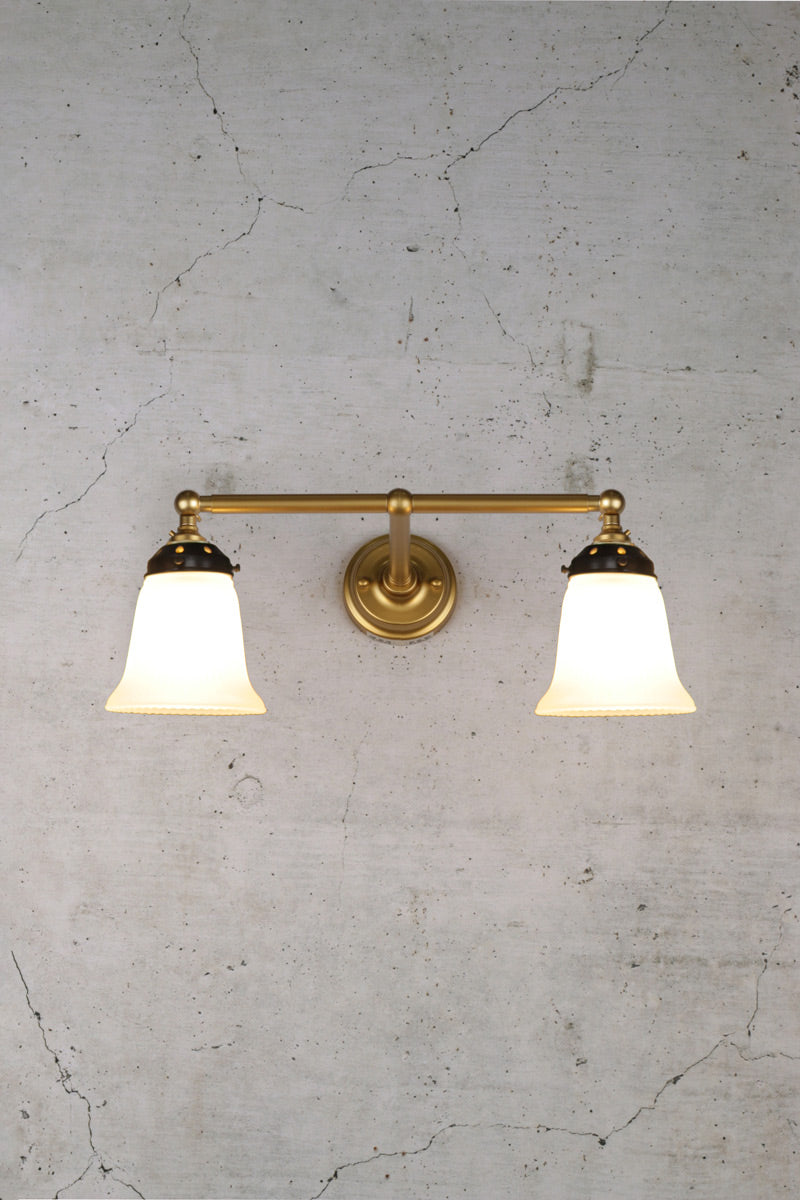 Gold double arm wall light with opal glass shades