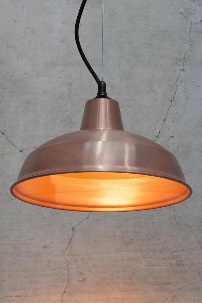 Small copper shade on a steel cable with black lampholder  and cord. 