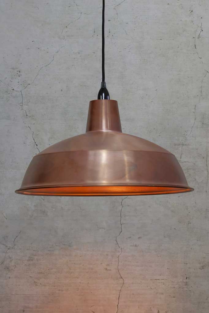 Small solid copper shade on black cord and black lampholder. 