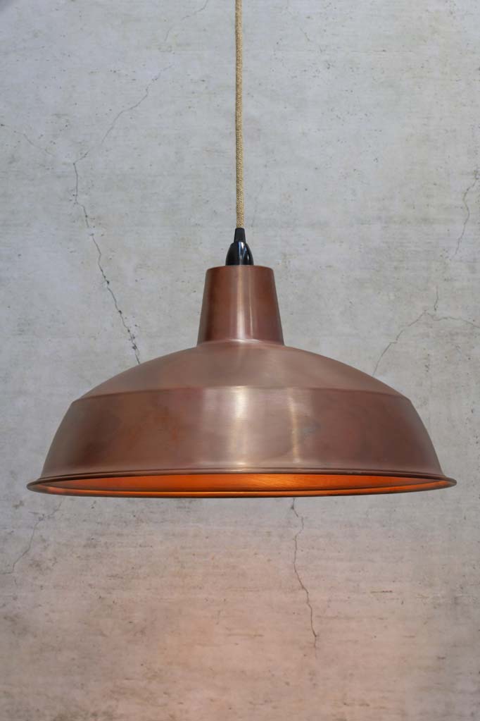 Large solid copper shade on jute cord and black lampholder. 