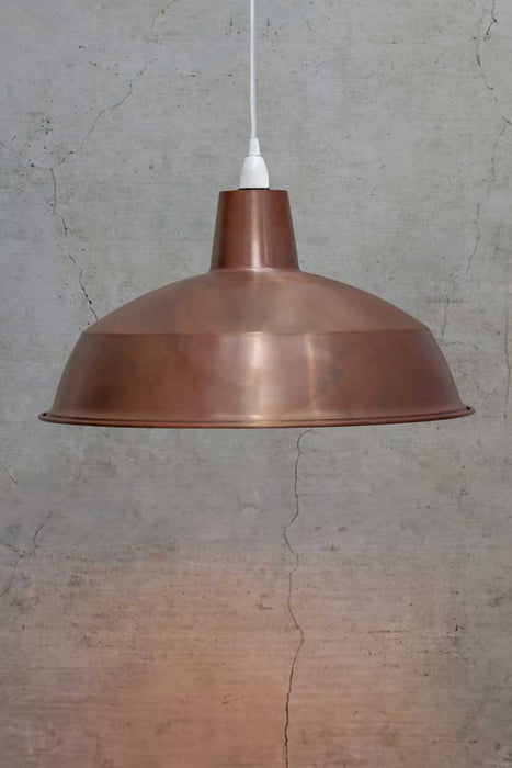 large copper pendant with white cord