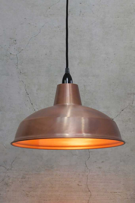 Large solid copper shade on black cord and black lampholder. 