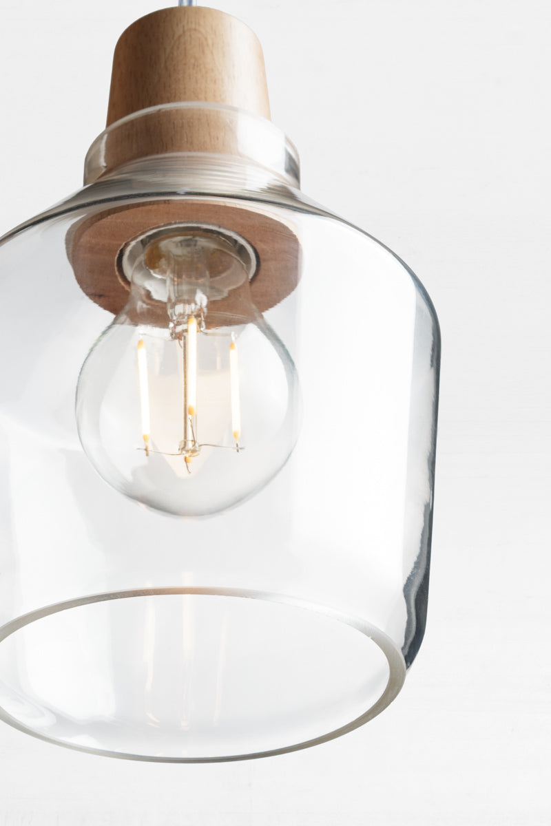 Close up of the small wood top glass light pendant with led bulb