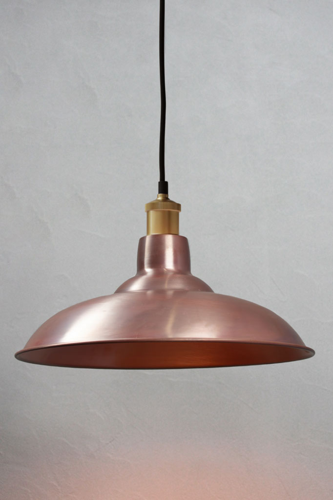 Solid Aged Copper bullpit shade on a black pendant cord with gold lampholder.