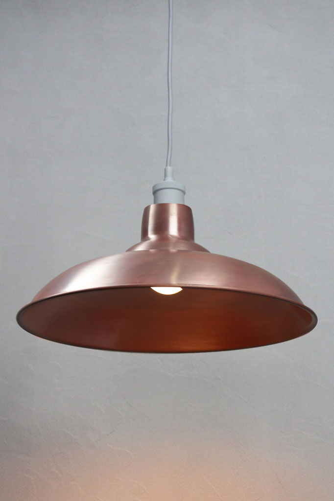 Solid Aged Copper bullpit shade on a white pendant cord. 