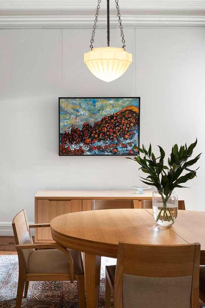 Riviera Chain Pendant in matt black finish with warm bulb over dining table.