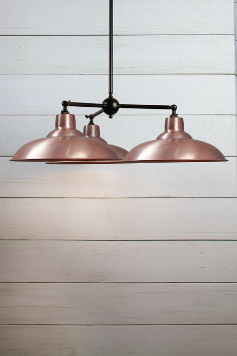 Bullpit Chandelier with three aged solid copper shades on a black, steel, three arm fixture.