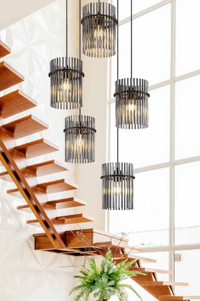 The Chrysler 5 shade chandelier hanging in a bright stairwell