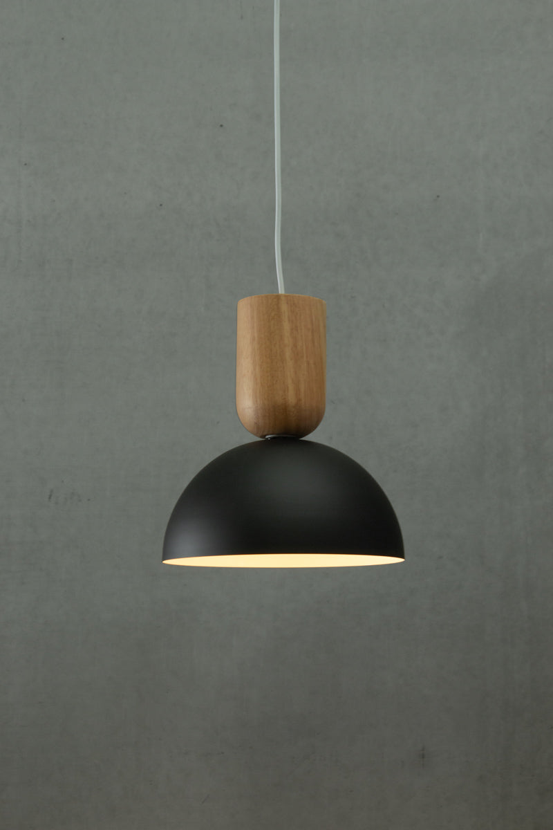 wooden blocks hanging with small black dome shade