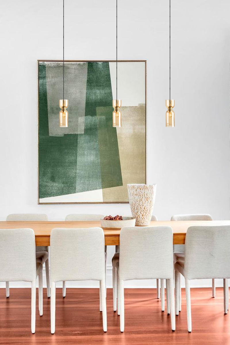 amber glass pendants over dining tabel