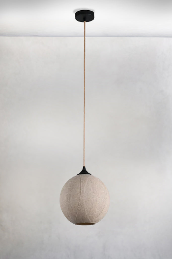 Round pendant light in glass with a linen and black finish light off. 