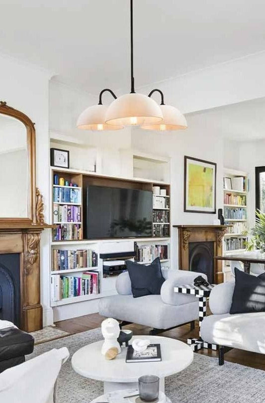 Glass chandelier over coffee table in the middle of a living room 