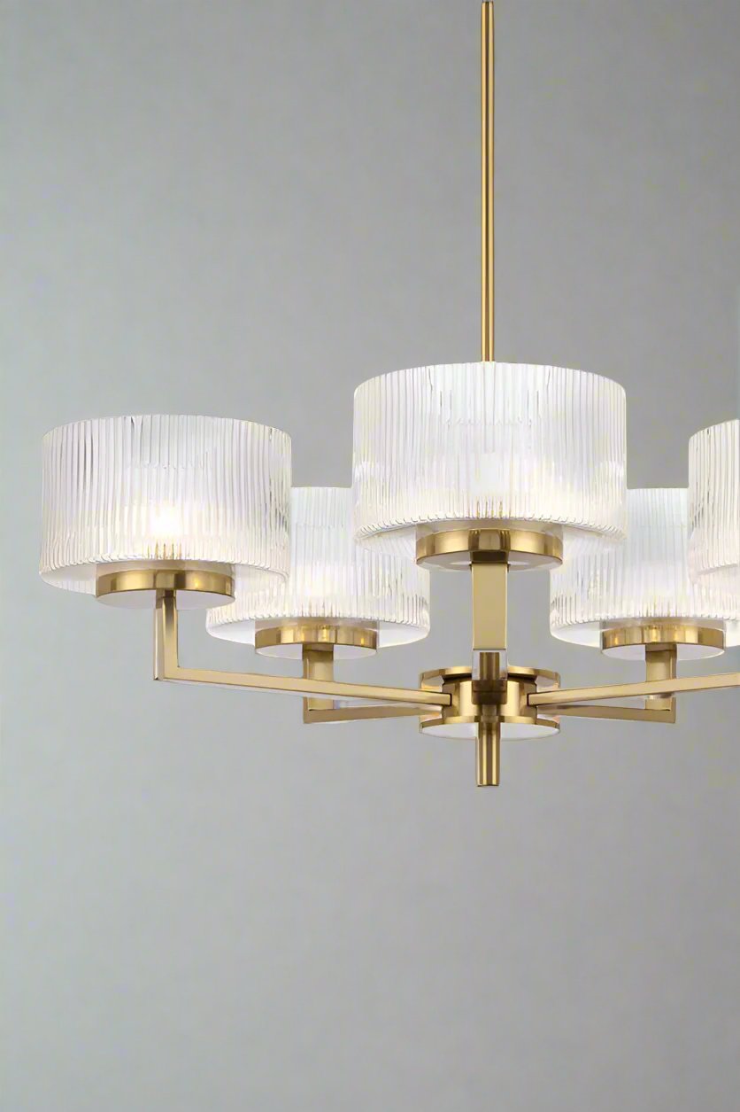 Aalto Reeded Glass Chandelier with five shades in antique gold in a bedroom.