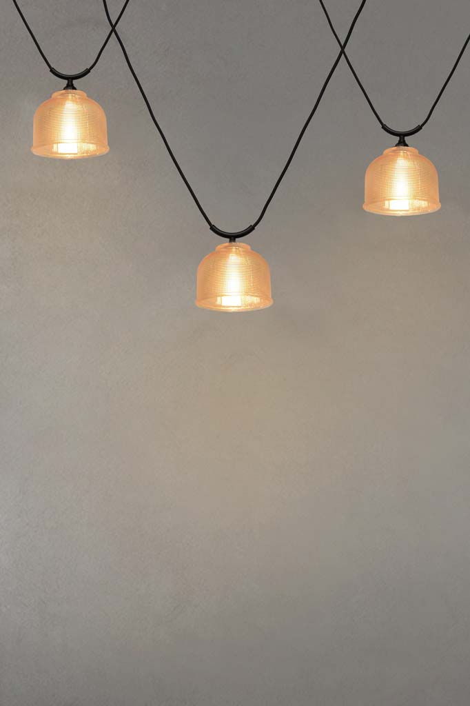 Three Chapman Glass Trapeze Pendants with amber shades.