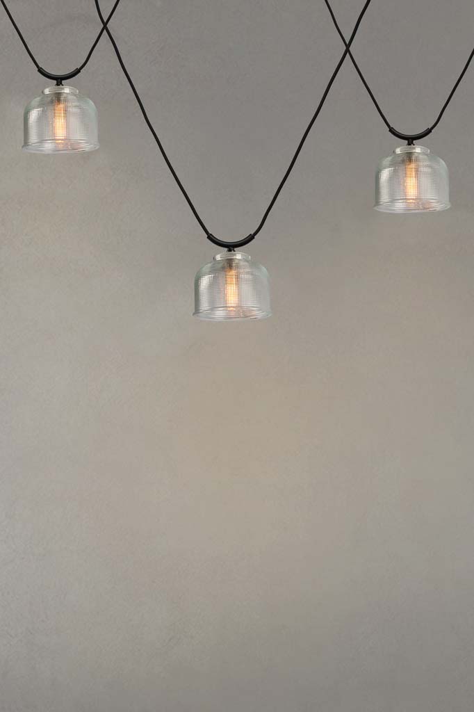 Three Chapman Glass Trapeze Pendants with clear shades.