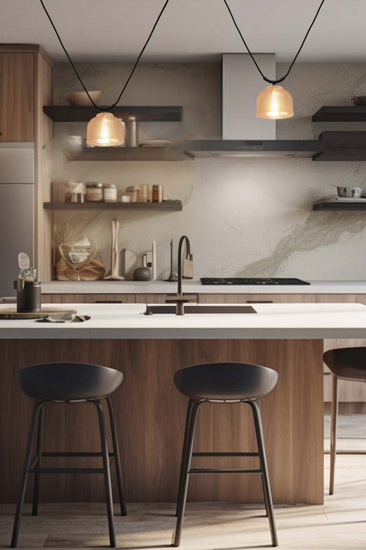 Two Chapman Glass Trapeze Pendants with amber shades hanging in an earthy toned kitchen.