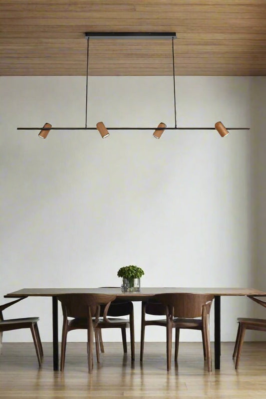 Cine pendant linear pendant light with four timber look shades above a dining space. 