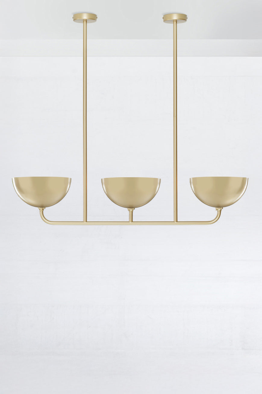 3 lamp Linear Chandelier in gold/brass, with small gold/brass Dome shades.