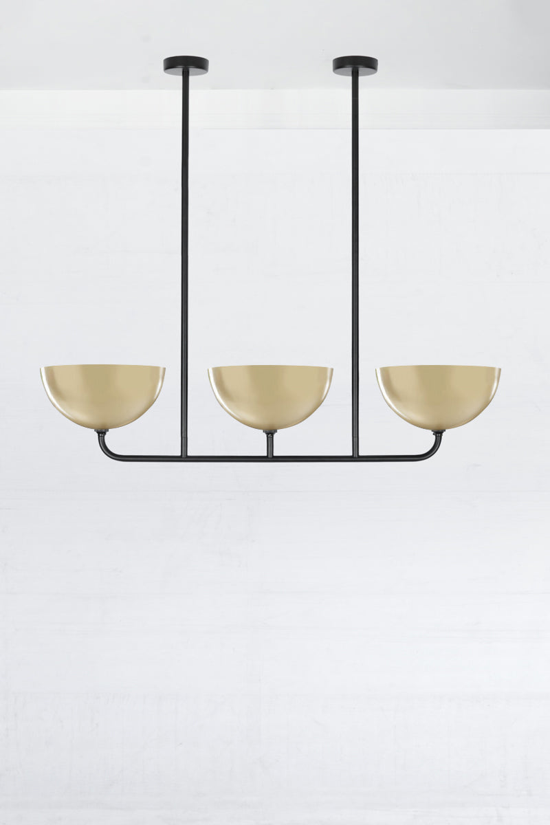 3 lamp Linear Chandelier in black, with gold/brass Dome shades.