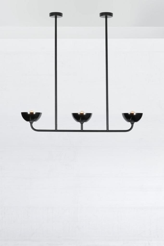 Black triple light linear chandelier with black bakelite shades. 