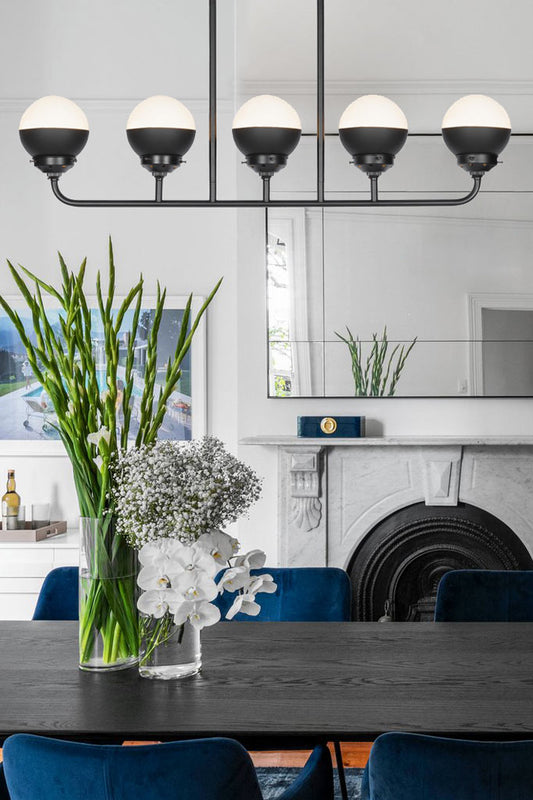 Black crown sphere shades on the five ligh linear chandelier.