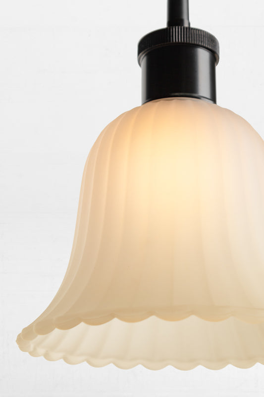 Provides diffused lighting through its frost glass shade and scalloped edging