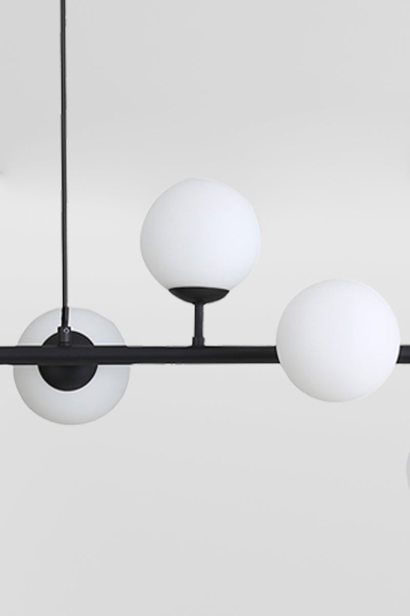 Close up of the black 6 light linear glass ball pendant light. 