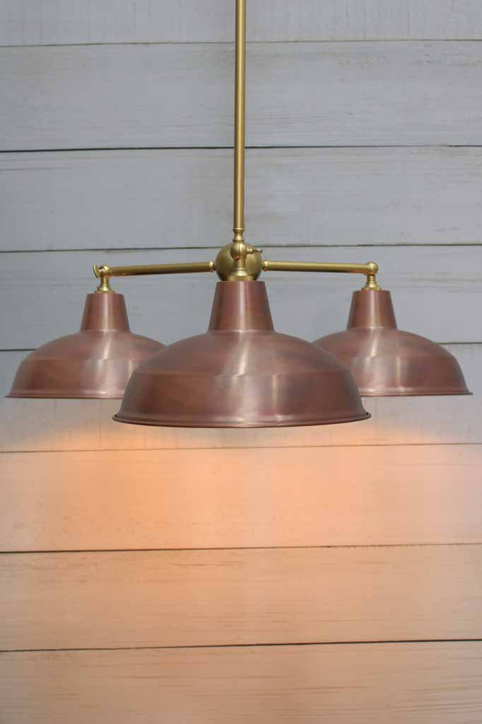 Industrial triple Warehouse Chandelier with gold/brass fixture and copper shades.