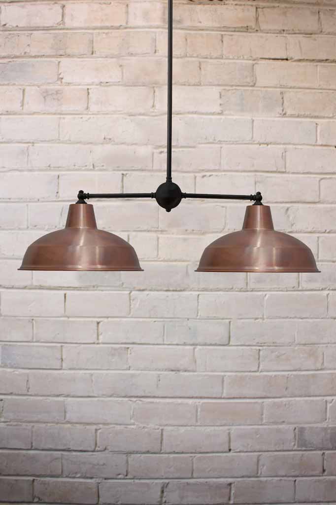 Industrial double Warehouse Chandelier with black fixture and copper shades.