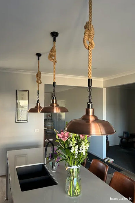 Three copper rope pendants over a customers kitchen bench.