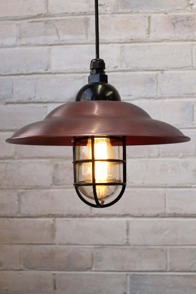 Industrial Bunker Pendant Light with a copper shade and clear glass.