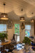 Three wicker woven pendant lights in a customers dining/kitchen space. 