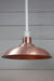 copper shade on white pole