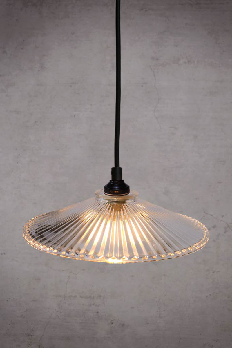 Top view of the plymount glass pendant with black braided cloth cord. 