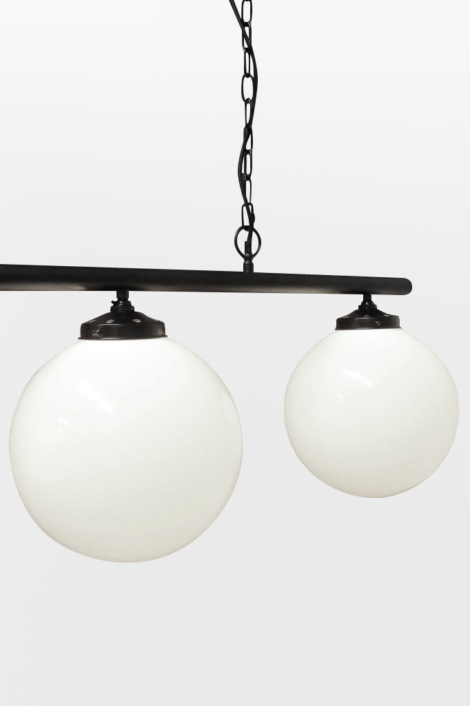 Close up of the medium opal glass ball shades on the lack linear light bar. 