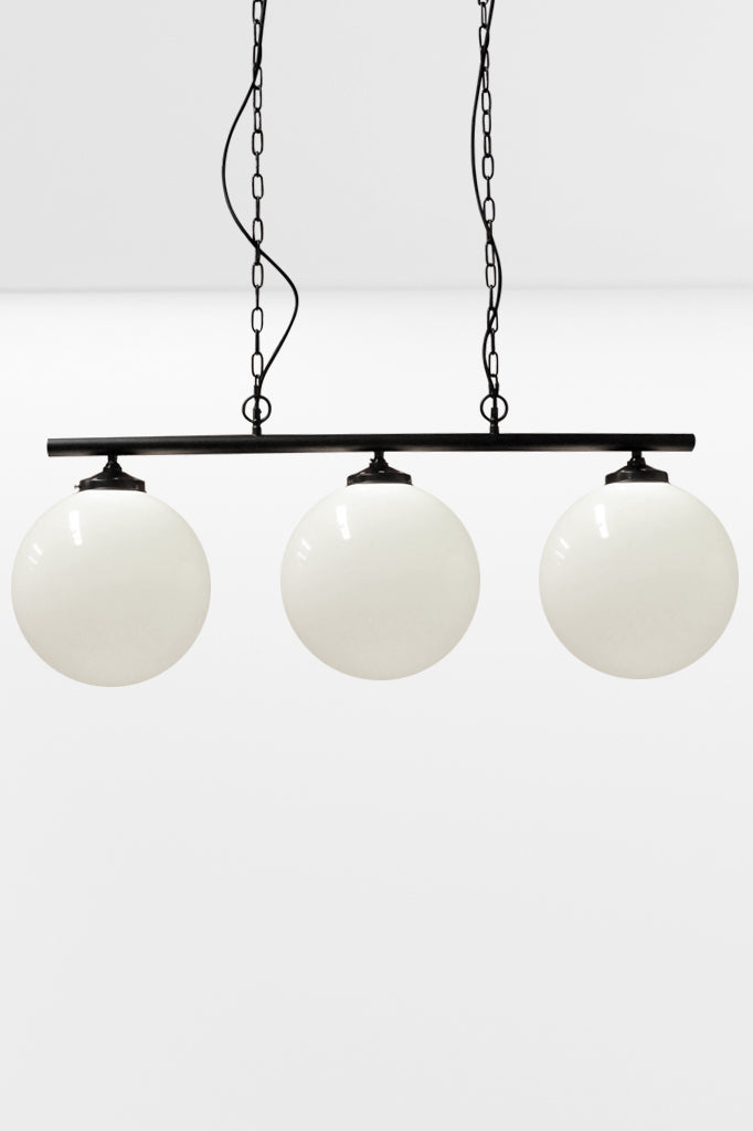 Large opal shades on the 3 light linear bar in black with chain and cloth cord. 