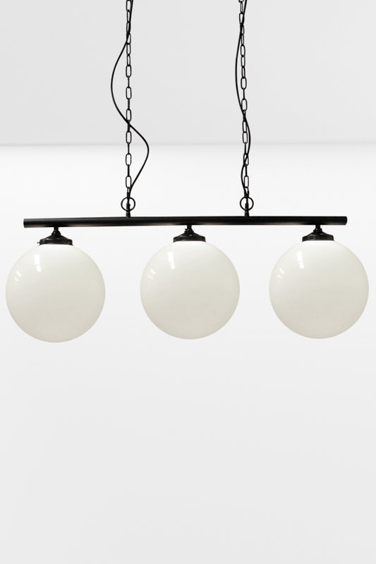 Large opal shades on the 3 light linear bar in black with chain and cloth cord. 