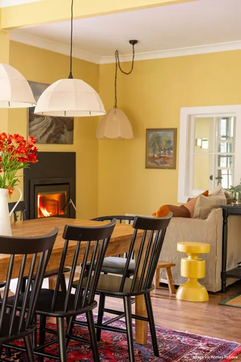 Missuri fabric light with black chain hung in the lounge space of a yellow farmhouse space. Image via Homes to Love. 