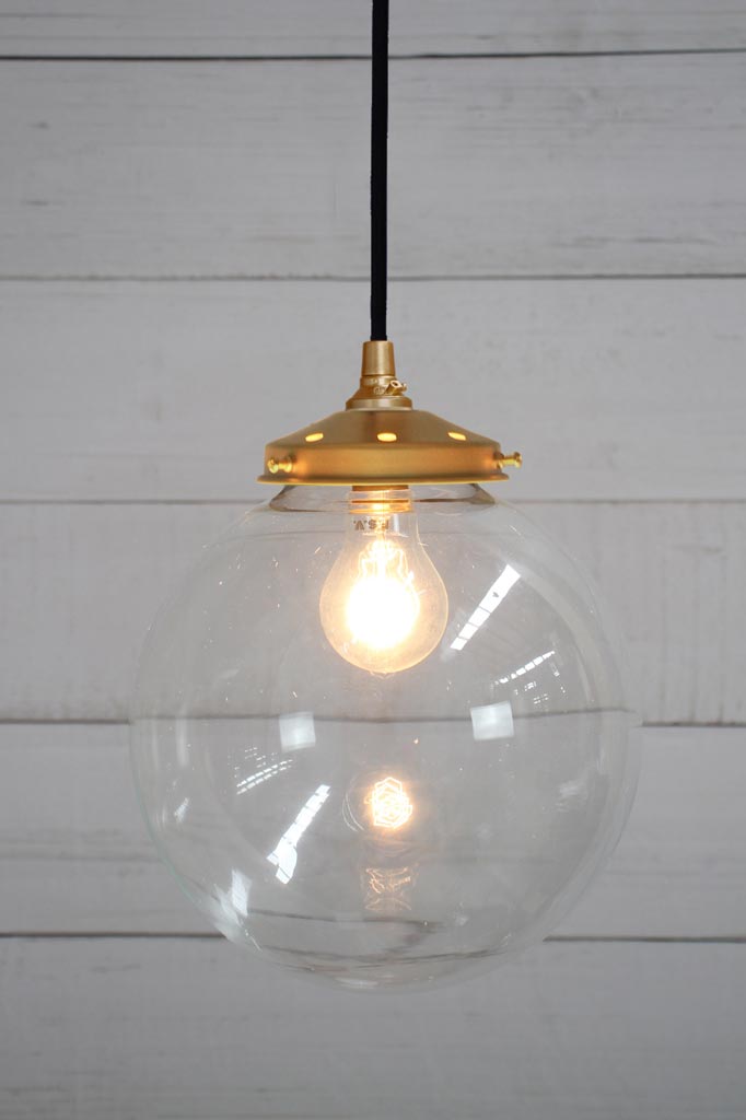 Gold brass round cord pendant light with medium clear shade