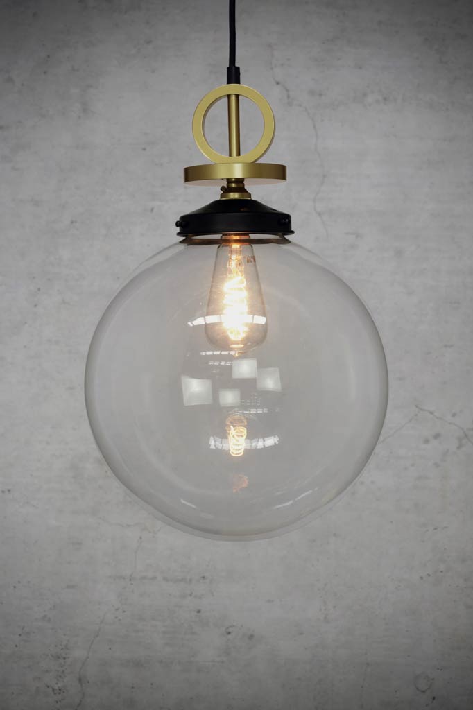 large clear glass pendant with gold brass disc cord