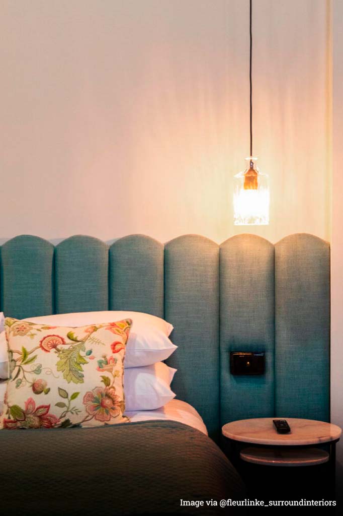 Retro 1920s lighting glassware over a bedside table in a bedroom