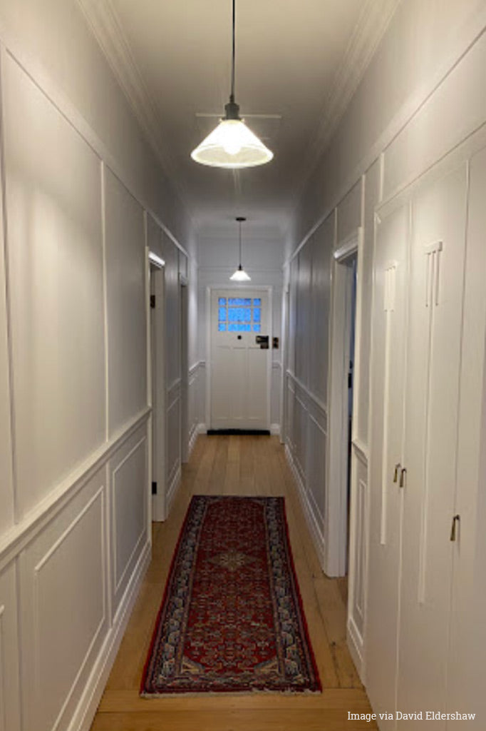 Image via David Eldershaw, 2 pleated pendants in an entrance hall.